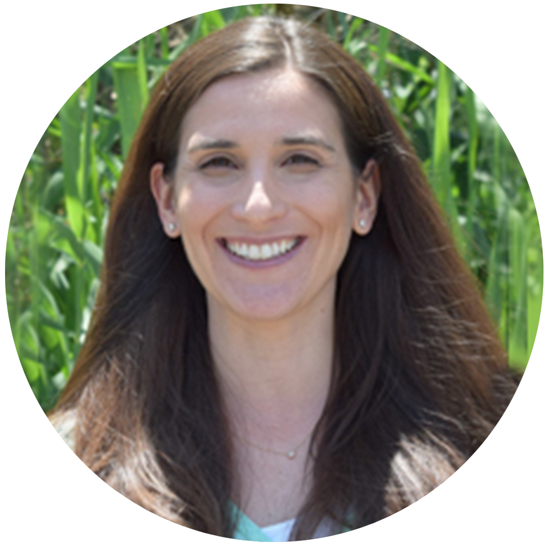 Headshot of PhD Research student Carrie Cottone in front of greenery